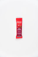 A hand adding No Days Wasted Hydration Replenisher to a glass of water.