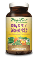 Close-up of MegaFood Baby & Me 2 tablets next to a glass of water, highlighting a prenatal vitamin designed for expecting mothers.